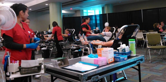 People reclined in chairs donating blood
